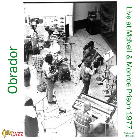 Live at McNeil & Monroe Prisons 1977 — cover art. Black-and-white photo of Obrador performing indoors, shot from above — piano, conga, drum kit, guitar and saxophone visible, with a barred window in the background. The OlyJazz logo sits lower left; "OlyJazz #9 / GM1136" is printed lower right.