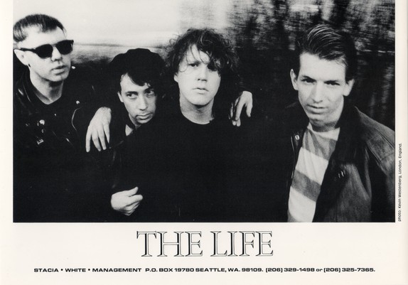 Black-and-white promotional band photo of The Life's four members, credited to photographer Kevin Westenberg, London, England.